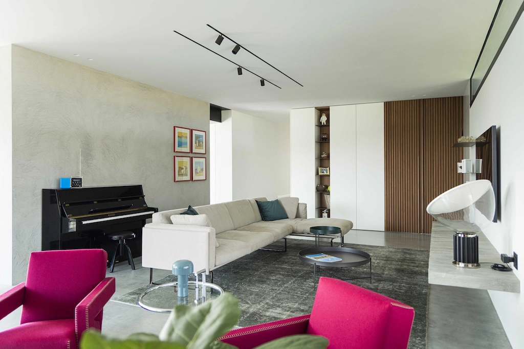 Casa CT — modern living room with grey sofa, red Cassina armchairs and wood strip wall, interior design Vicenza