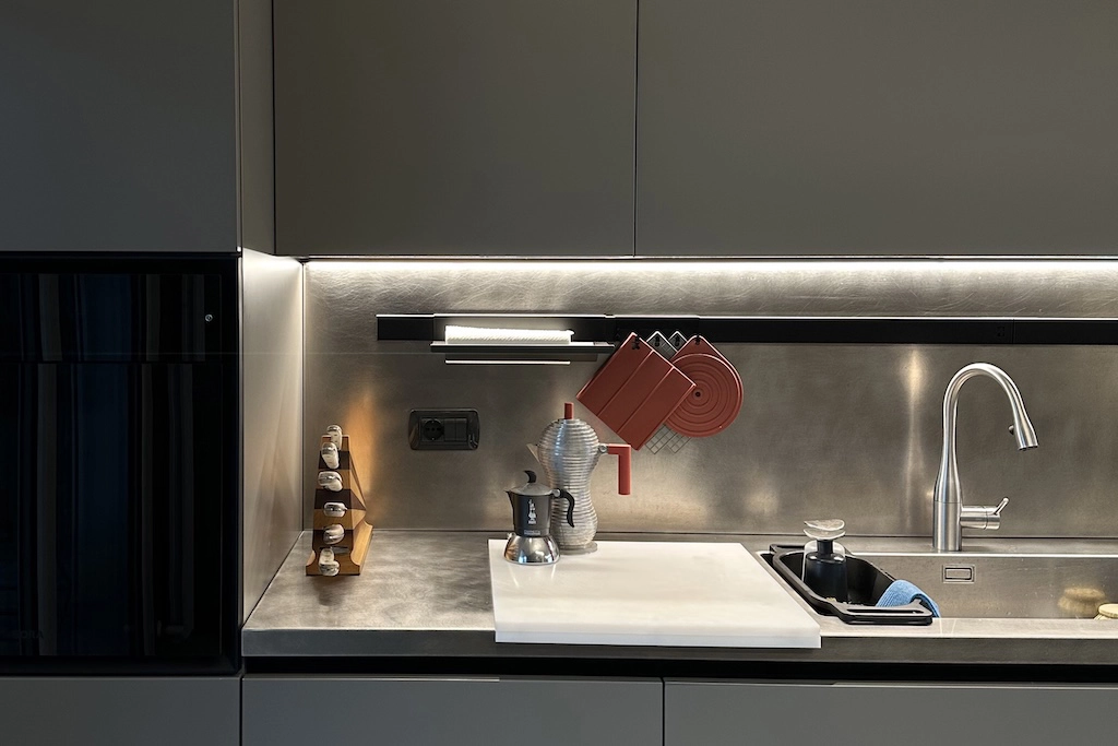 Casa BB — kitchen close up with stainless steel splashback, Bialetti moka pot and designer accessories, interior design Vicenza